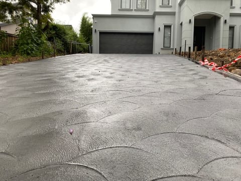 Large grey concrete driveway installation in Western Sydney