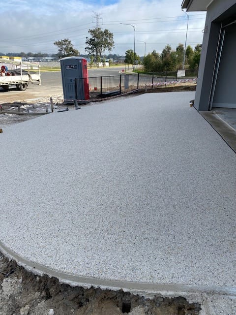 Exposed aggregate driveway finish by Kayssa Landscaping